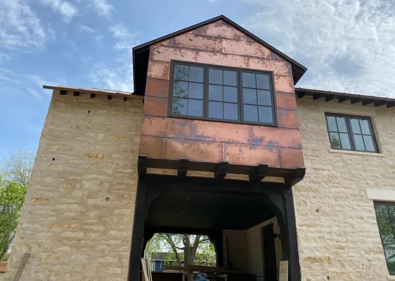 Copper metal panel facade on a stone building for Skylight Installation in Rancho Murieta