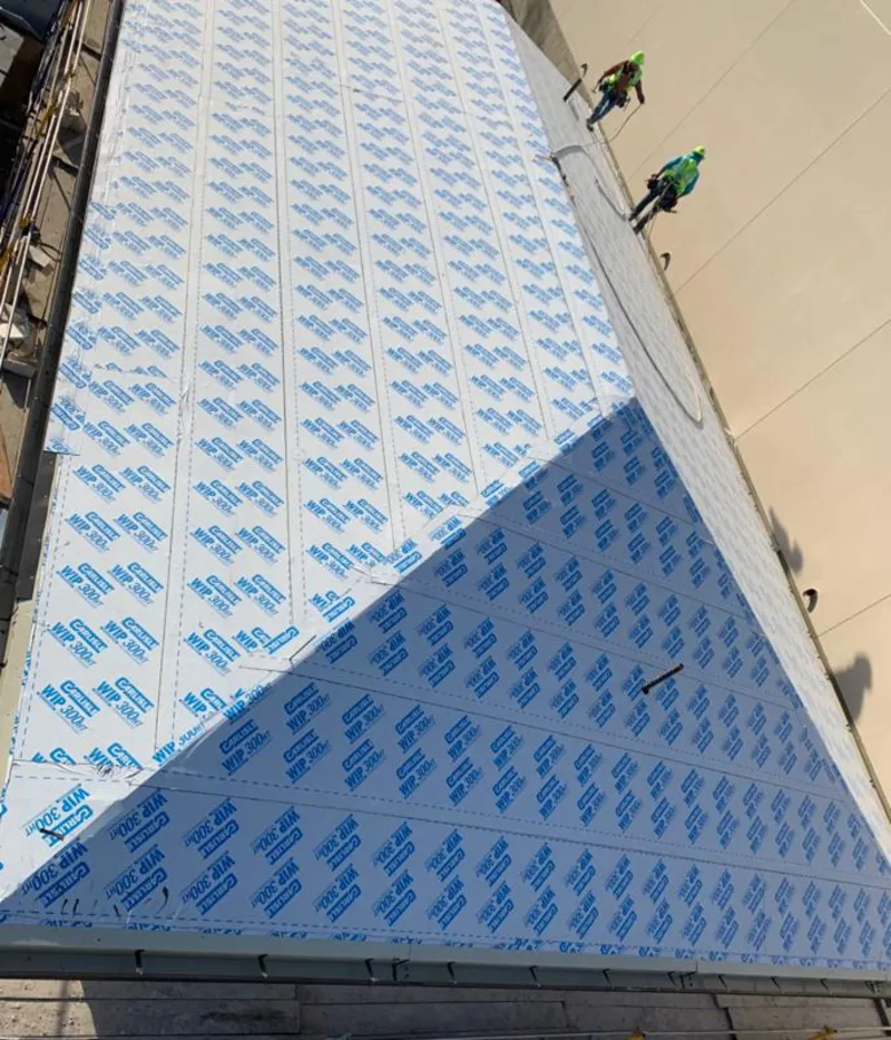 Professional roofers installing underlayment on a metal roof in Rancho Murieta